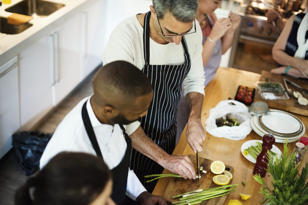 Group of friends cooking in the kitchen