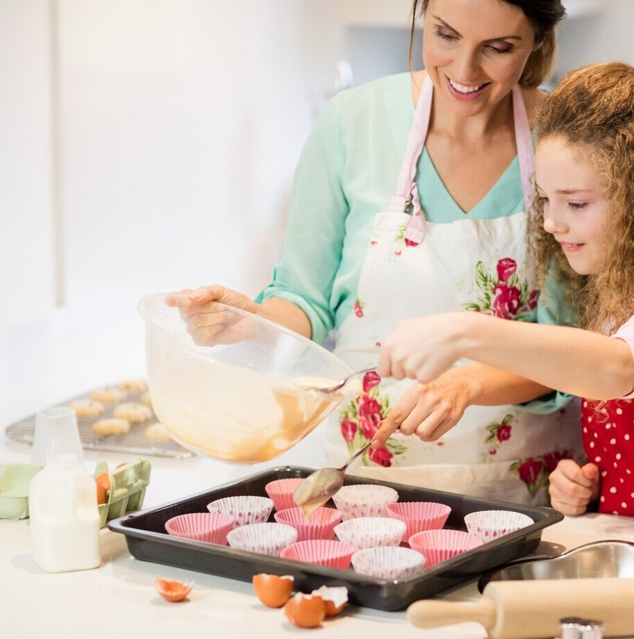 mother-daughter-preparing-cupcake-kitchen_1170-2851